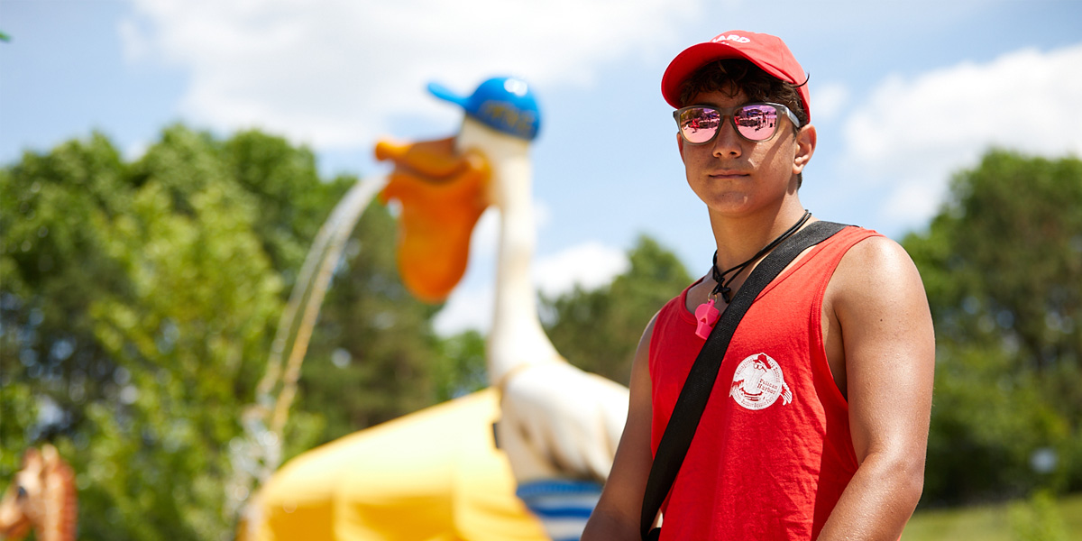 white teenage male lifeguard on duty at Pelican Harbor