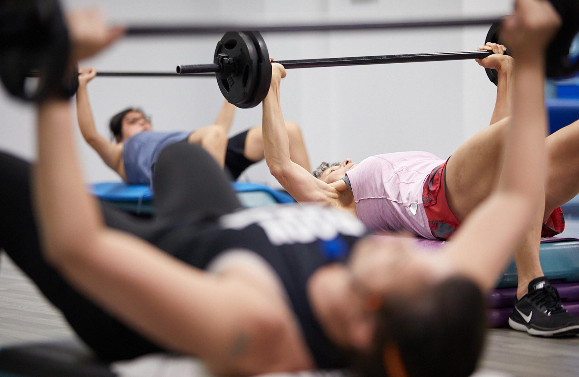 fitness class doing bench press with weights