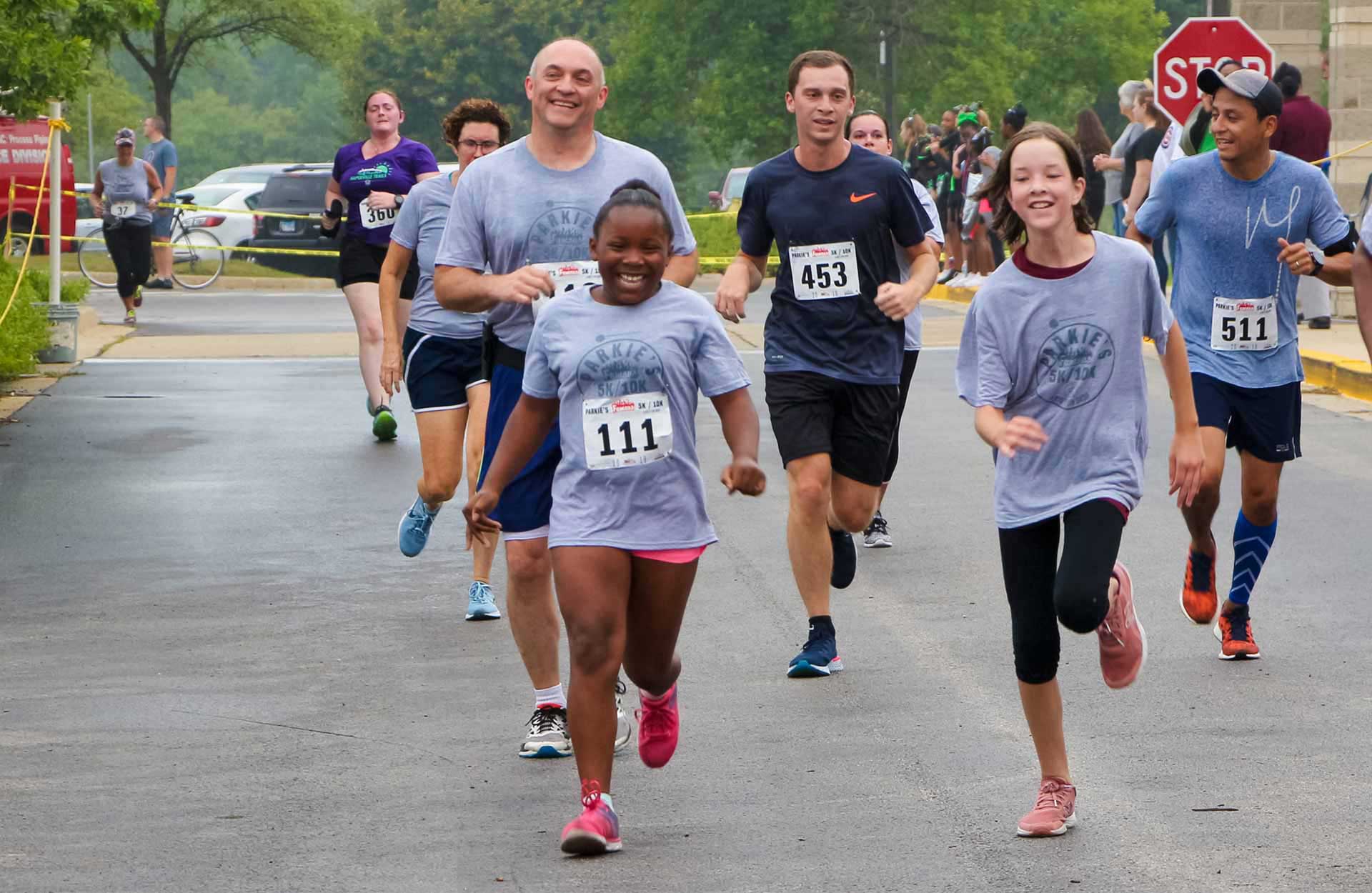 children and adults running in a race